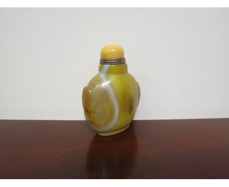 A 19th Century Chinese yellow jade snuff bottle with polished yellow stone stopper and integral spoon, 8.5cm tall 