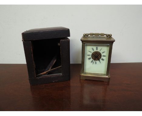A late 19th early 20th Century brass cased carriage clock with single train movement, cream enamelled dial, with later case a