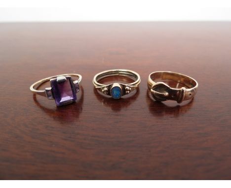 Three 9ct gold rings including opal, amethyst and buckle example