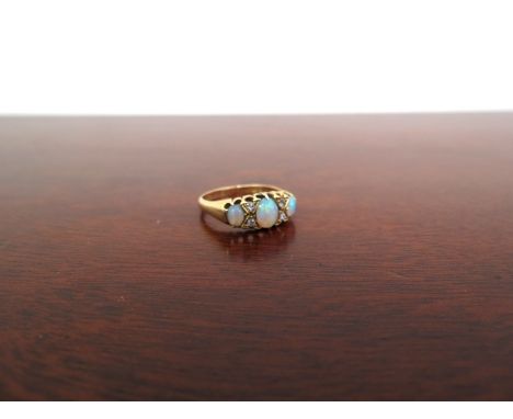 An 18ct gold opal and diamond ring