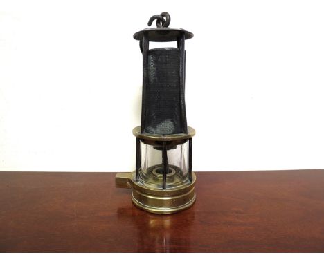 A brass and steel miner's lamp, open gauze protected by four rods