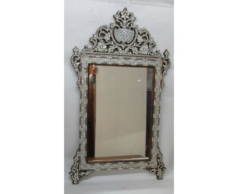 A late 19th/early 20th century Anglo Indian mother of pearl and bone inlaid wooden mirror with the fretwork crest fashioned a