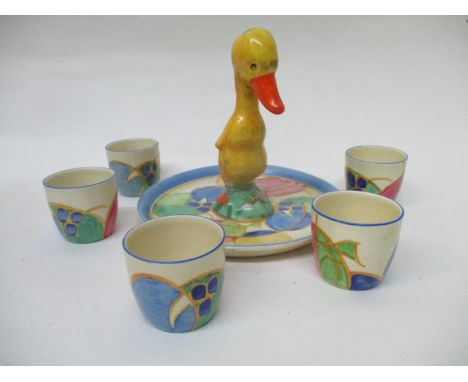A Clarice Cliff Melon pattern duck egg cruet, comprising of a tray painted in colours, inside a blue band of five Bizarre egg