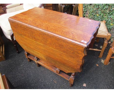 A 1930s oak gate leg table on barley twist legs, 29" h x 35 1/2"w 