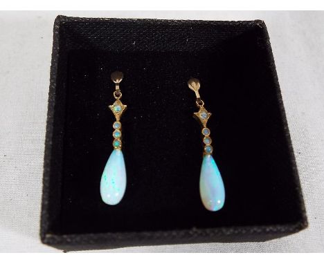 A pair of 9 carat gold drop earrings set with opal