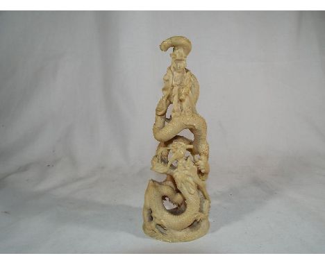 A highly carved mid 19th century worked ivory Chinese statue depicting a Goddess surrounded by a dragon 19 cm (h) inscribed  