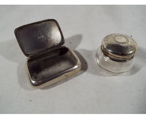 A George V silver snuff box Birmingham assay 1923 and a small glass jar with hallmarked silver cap, Birmingham assay 1926