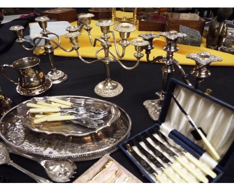 A collection of good quality silver plated ware to include three candlesticks, serving tray, tankard and a quantity of boxed 