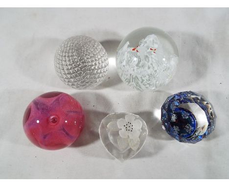 A collection of four glass domed paper weights and one heart shaped trinket dish to include Swarovski, Caithness, Sea Gems, a