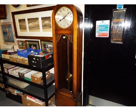 A good oak cased Art Deco style Westminster chiming grandmother longcase clock, the dome topped case having opening glazed do