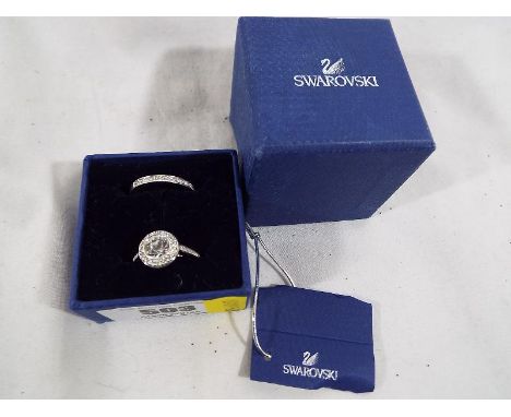 Two Swarovski crystal fashion rings, stone set both sized K and a half. Estimate £30 - £50