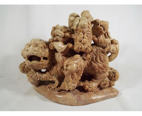 A good quality Chinese finely carved soapstone statue depicting Foo dragons/dogs sitting on a rosewood plinth 24 cm x 27 cm E