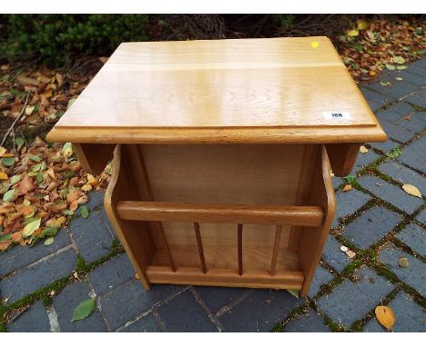 A good light wood rectangular side table incorporating a magazine rack by ONA, 56 cm x 46 cm x 35 cm