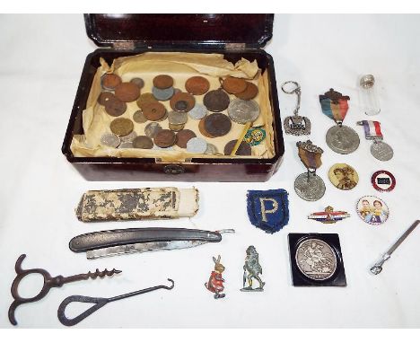A lacquered wooden box containing a collection of predominantly pre-decimal UK and world coins to include a Victorian Crown c