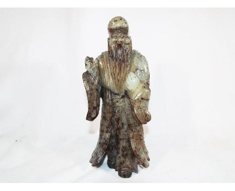 A highly carved Chinese jade statue depicting a gentleman, inscribed to the base with signature, 21.5 cm (h) Estimate £800 - 