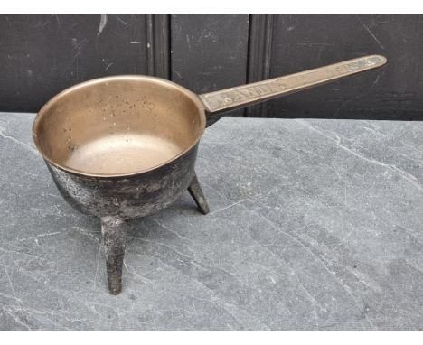 A Georgian bronze tripod skillet,&nbsp;the handle indistinctly inscribed 'Band ...No. II', 38.5cm long, (casting splits).