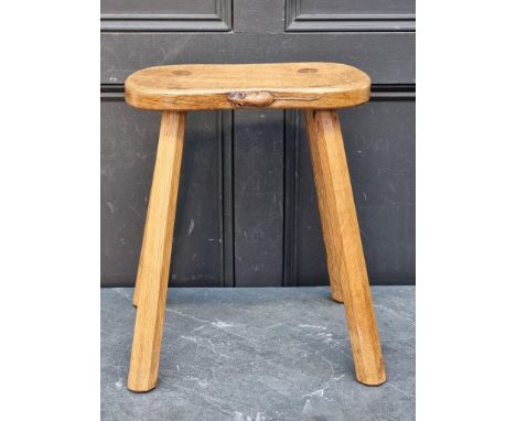 A Robert 'Mouseman' Thompson four legged cow stool, 37cm wide.