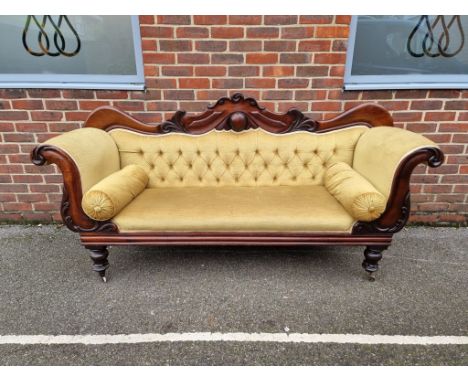 An early Victorian carved mahogany and button upholstered scroll arm settee, 201cm wide.