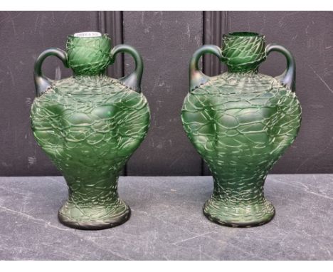 A pair of Loetz style twin handled green glass vases,&nbsp;19.5cm high.