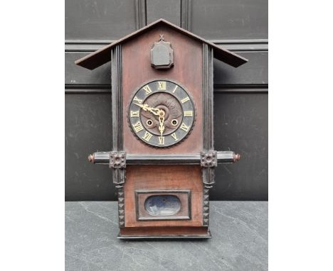 A late 19th century Continental walnut and ebonized cuckoo clock,&nbsp;57.5cm high, with pendulum.