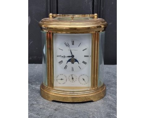 A good brass oval carriage clock, by Matthew Norman, with calendar, moon-phase alarm and day dials, striking on a gong, with 