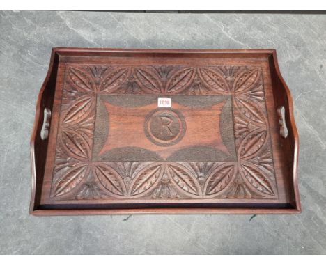 A carved mahogany twin handled tray, inscribed 'R', 56cm wide.