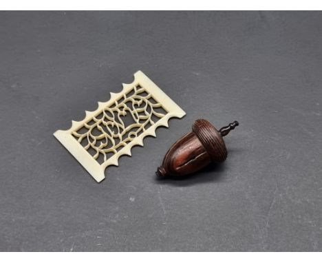 A 19th century carved bone thread winder,&nbsp;inscribed 'Ann', 5cm wide; together with&nbsp;a turned rosewood acorn thimble 