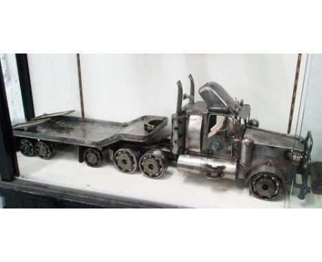 MODEL OF AN AMERICAN TRUCK AND TRAILER, made from machine parts, 96cm L.