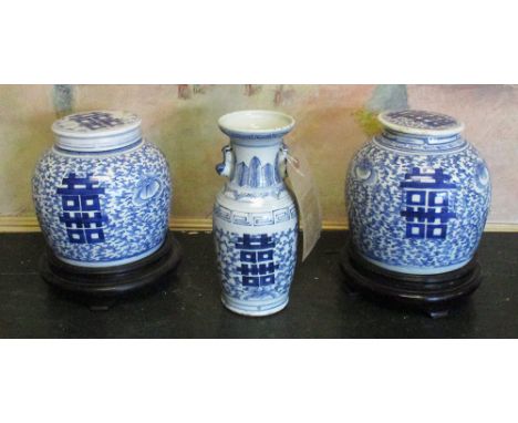 VASES, a pair, Chinese Kanxi style blue and white ceramic with covers on ebonised stands, 24cm H x 19cm D. together with a bl