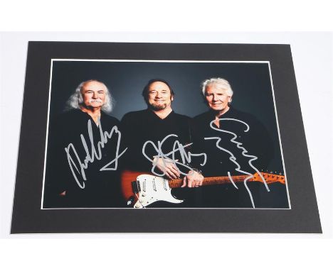 Studio portrait of Crosby, Stills and Nash, 10 x 8 colour close-up photo signed by all three in silver pen. Complete with Cer