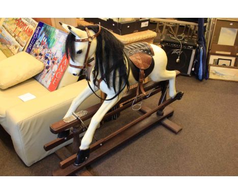 White painted rocking horse on stained safety stand