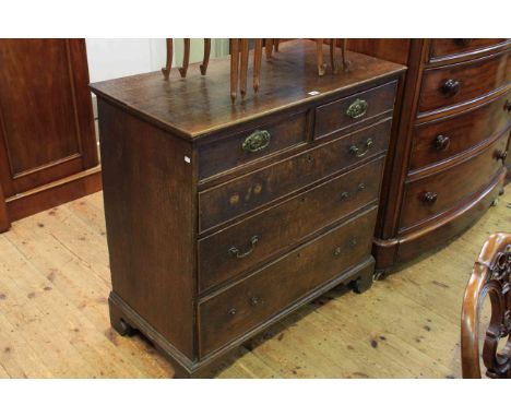 Georgian oak chest of two short above three long drawers on shaped bracket feet (woodworm to back panel)