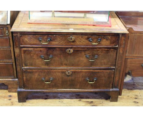 Georgian walnut three drawer chest on bracket feet