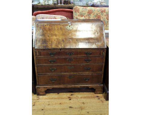 Georgian walnut four drawer bureau on bracket feet
