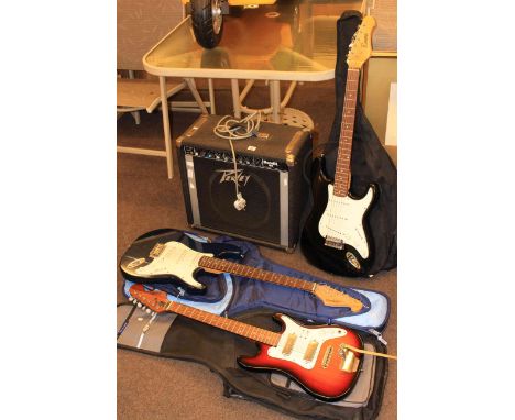 Three electric guitars and Peavey Bandit 65 amplifier