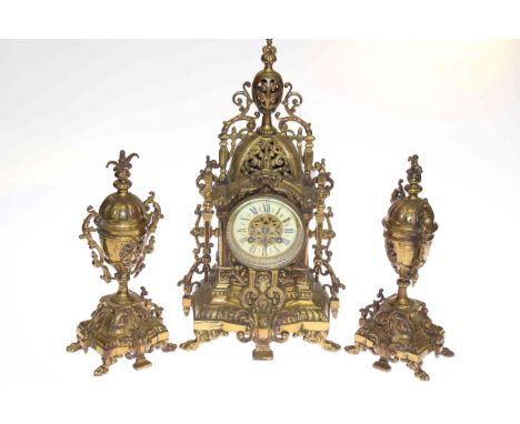 Ornate gilt metal three piece clock garniture with enamel dial