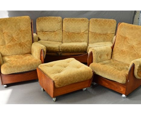 A G-PLAN TEAK FOUR PIECE SADDLE LOUNGE SUITE, with gold upholstery, Pirelli padding on orbit castors, comprising of a three s