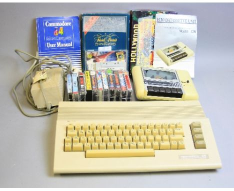 A COMMODORE 64 VINTAGE PERSONAL COMPUTER, with Datassette, PSU, fourteen games and manuals