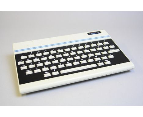 AN ORIC-1 VINTAGE COMPUTER, with power supply and twenty four cassette tapes with programmes and games