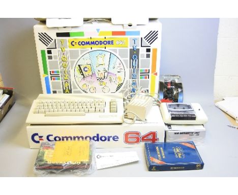 A BOXED COMMODORE 64C VIDEO PACK VINTAGE PERSONAL COMPUTER, with original packaging, power supply, a C2N Datassette unit, a Q