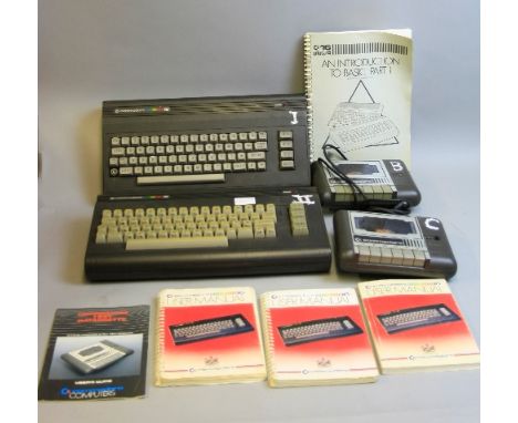 A BOX CONTAINING TWO COMMODORE 16 VINTAGE GAMING COMPUTERS, with two datassettes, three power supplies, three mouses, three u