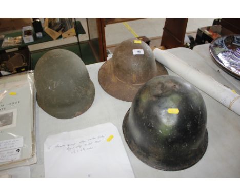 An American helmet and two other helmets 