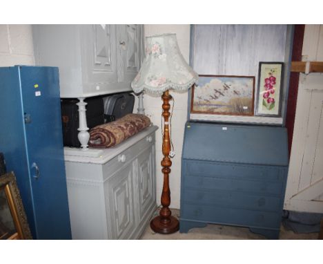 A turned standard lamp and floral shade