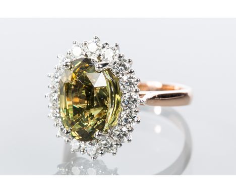 CERTIFICATED GREEN/ORANGE ALEXANDRITE AND DIAMOND CLUSTER RING
the oval cut alexandrite of approximately 6.35 carats, green i