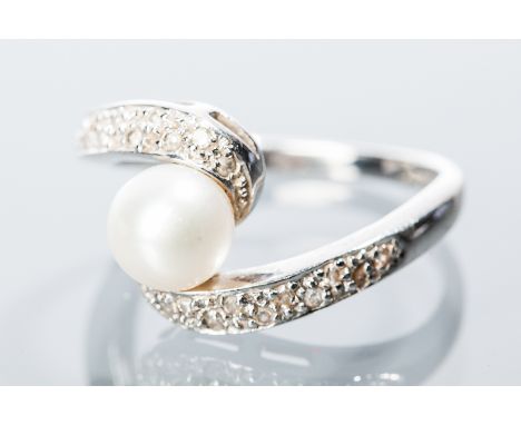 PEARL AND DIAMOND DRESS RING
the large central pearl approximately 7mm, on diamond set crossover shoulders, hallmarked nine c