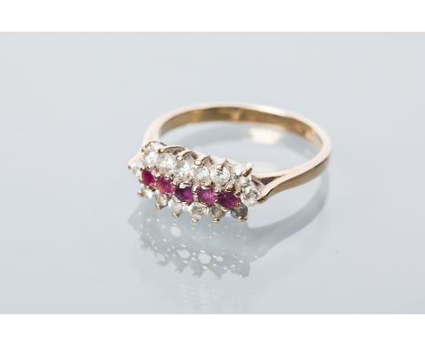 RUBY AND DIAMOND CLUSTER RING
set with five round rubies, surrounded by a row of brilliant cut diamonds, in nine carat gold, 