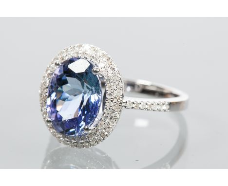 TANZANITE AND DIAMOND CLUSTER RING
set with an oval cut tanzanite of approximately 4.0 carats, surrounded by diamonds totalli