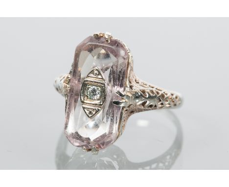 ART DECO AMETHYST AND DIAMOND DRESS RING 
with a rectangular amethyst and a central small brilliant cut diamond, in an ornate