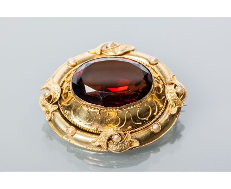 IMPRESSIVE VICTORIAN CITRINE AND PEARL BROOCH
set with a large central dark citrine, the border with scrolling decoration and