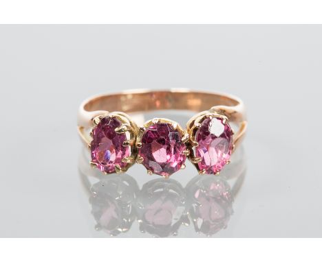 VICTORIAN GARNET THREE STONE RING
set with three oval cut garnets, on split shoulders, marks worn, size L-M